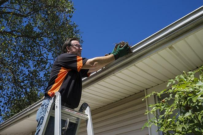 worker repairing a leak in a residential gutter in Burns Harbor IN